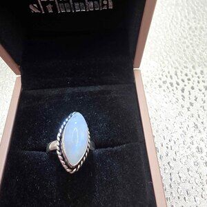 marquise-cut opalite or similar iridescent gemstone set in a rope-style bezel.